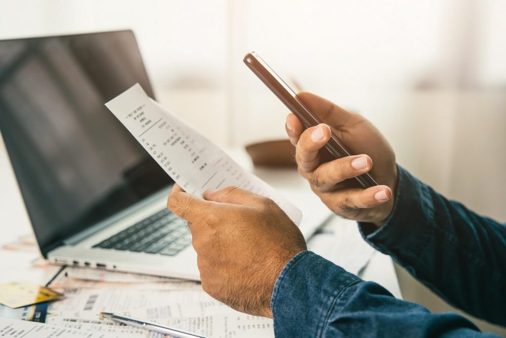 man taking photo of Proof of Domicile form